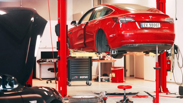 Tesla Service Center Drive-In with Tesla Model S lifted. Tesla workshop in Europe. — Photo by kle1njke@gmail.com