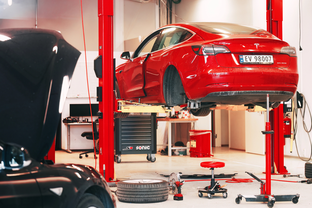 Tesla Service Center Drive-In with Tesla Model S lifted. Tesla workshop in Europe. — Photo by kle1njke@gmail.com