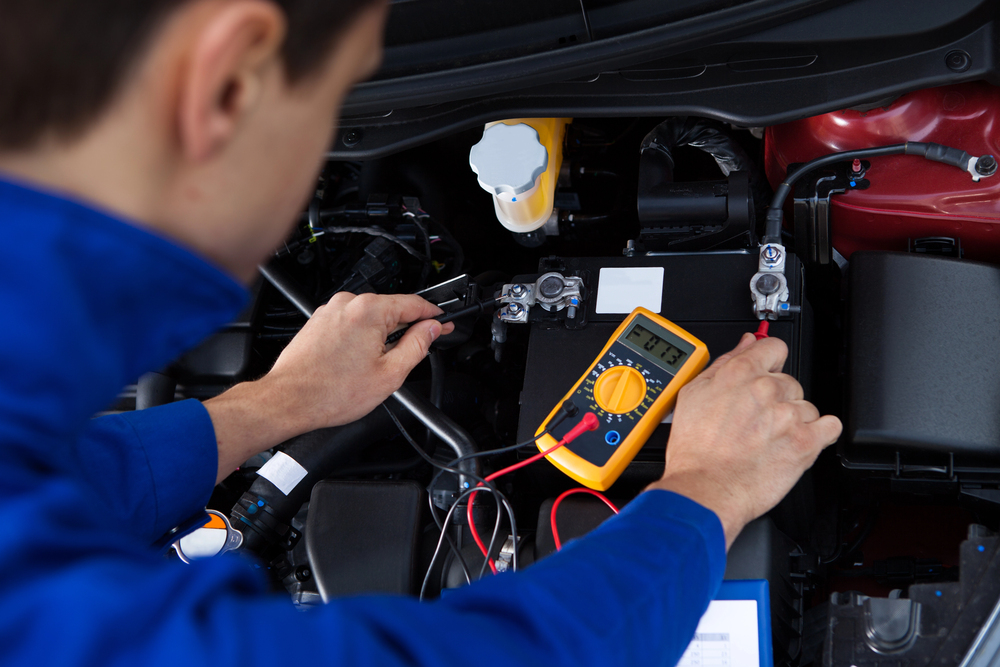 Mechanic Testing Car Battery