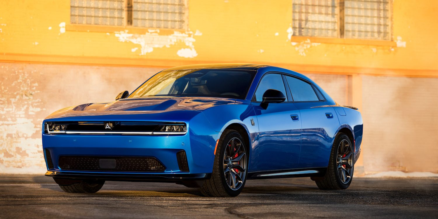 Four-door 2026 Dodge Charger Daytona Scat Pack Plus, shown in Bludicrous exterior color with Track Package, Blacktop Package and panoramic glass roof.