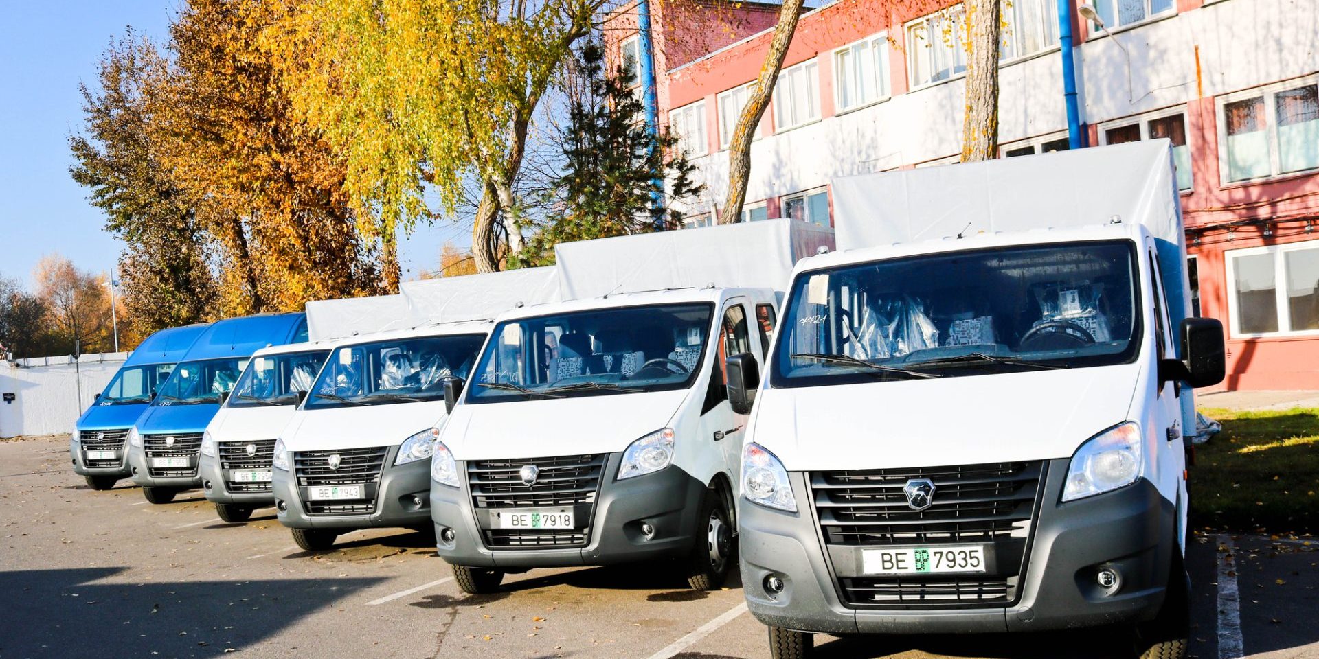 Small trucks, vans, courier minibuses stand in a row ready for delivery of goods on the terms of DAP, DDP according to the delivery terms of Incoterms 2010. Belarus, Minsk, August 13, 2018.