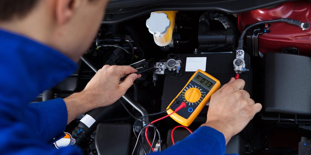 Mechanic Testing Car Battery