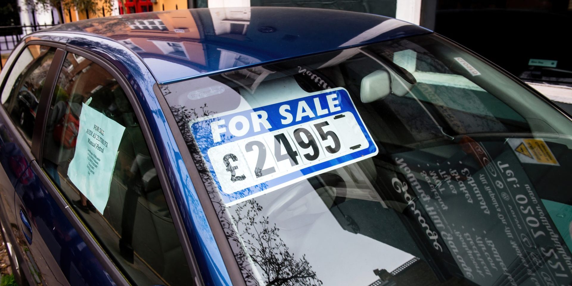 London, United Kingdom - Mar 9, 2017: For sale signage on the windshield of blue car with a price of 2495 UK pounds