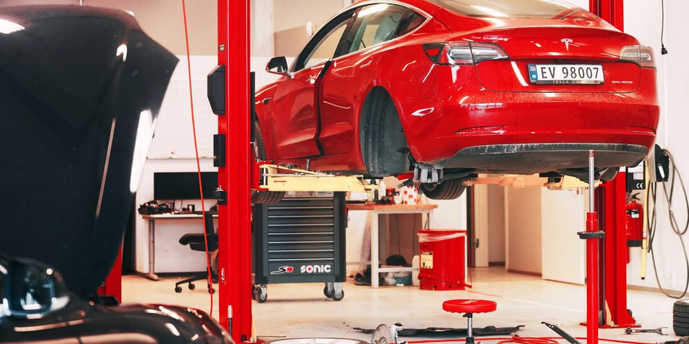 Tesla Service Center Drive-In with Tesla Model S lifted. Tesla workshop in Europe. — Photo by kle1njke@gmail.com