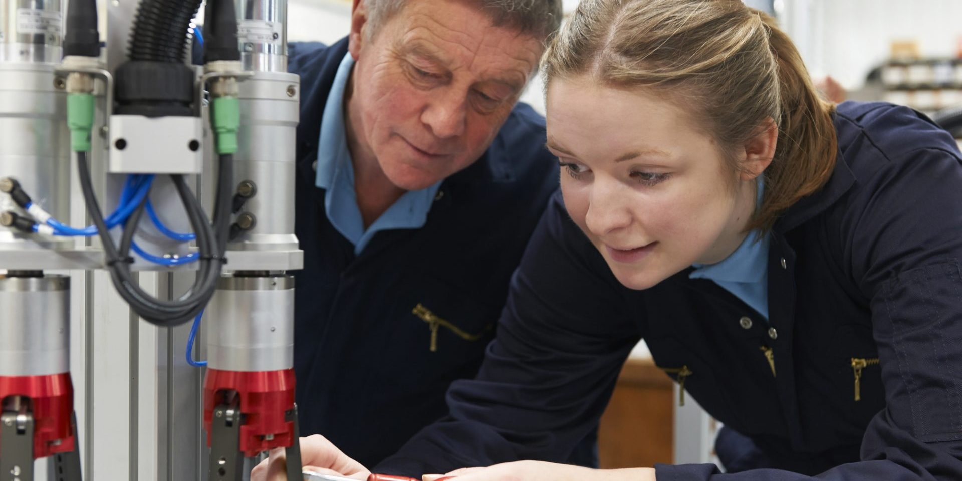 Engineer And Apprentice Working On Machine In Factory (image courtesy Deposit Photos)