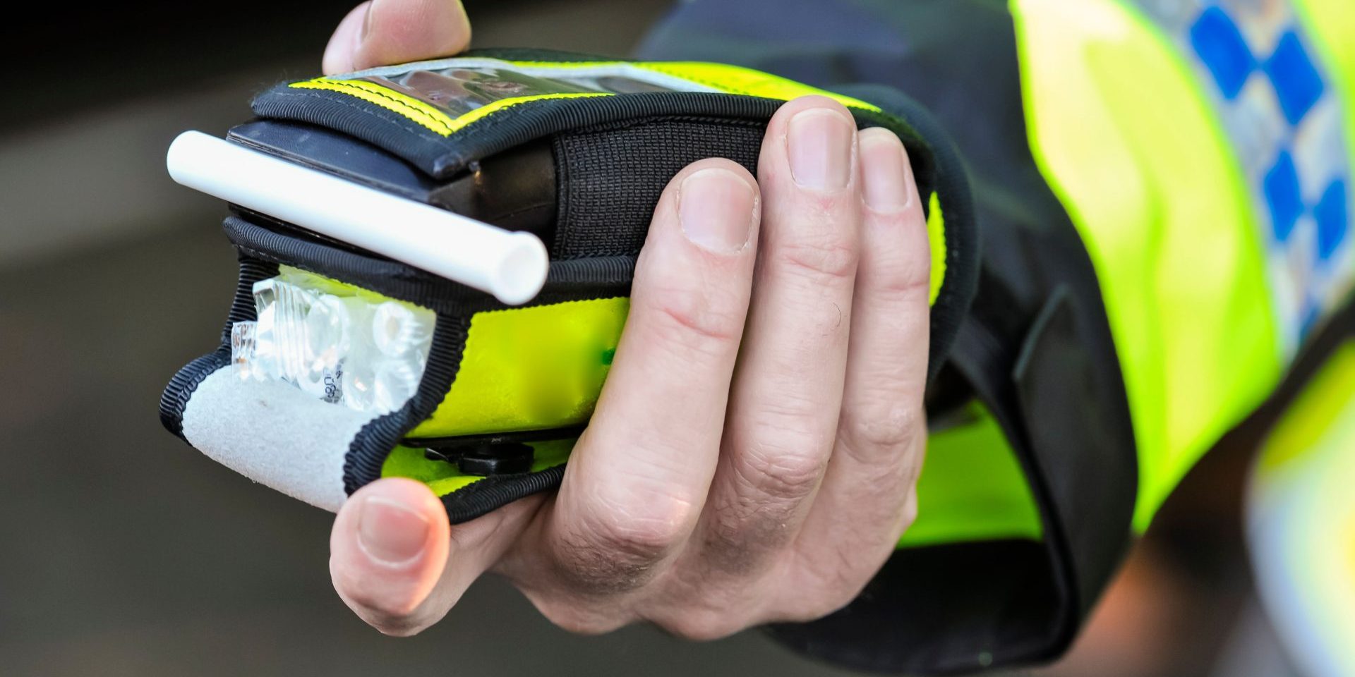 Belfast, Northern Ireland. 24 Nov 2016 - A police officer holds a roadside breathalyser alcohol breath test after taking a sample from a driver.