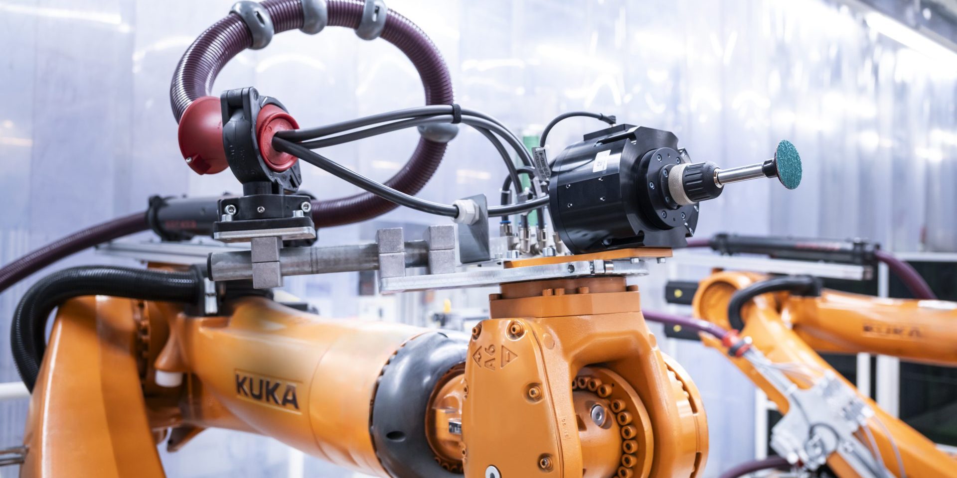 An AI application detects weld spatter on the underbody of a car body in the body shop at the Audi site in Neckarsulm, Germany. Thanks to a recent upgrade, a robotic arm has taken over grinding them down – a physically demanding task.