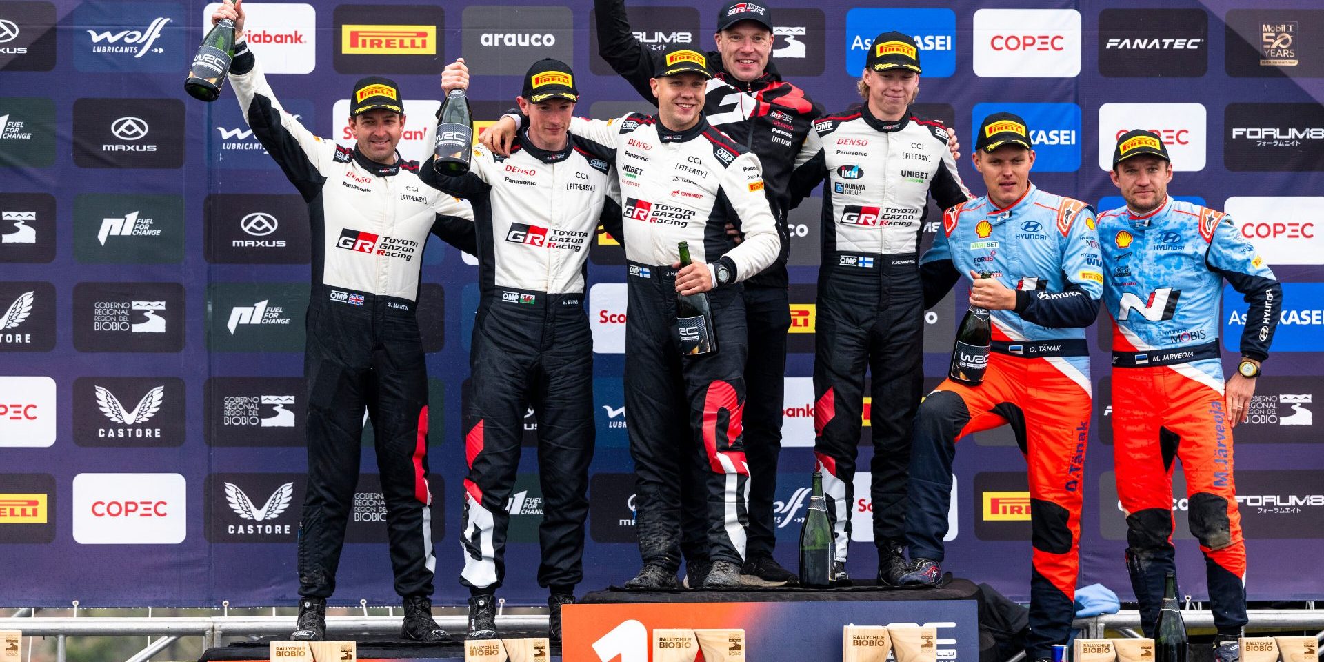 Kalle Rovanpera (FIN) and Jonne Halttunen (FIN) of team Toyota Gazoo Racing  celebrate on the podium in first place after winning the World Rally Championship in Conception , Chile on 29.09.2024 with  Elfyn Evans (GB) Scott Martin (GB) Of team TOYOTA GAZOO RACING WRT seccond and Ott Tänak (EST) Martin Järveoja (EST) Of team HYUNDAI SHELL MOBIS WORLD RALLY TEAM third place // Jaanus Ree / Red Bull Content Pool // SI202409290767 // Usage for editorial use only //