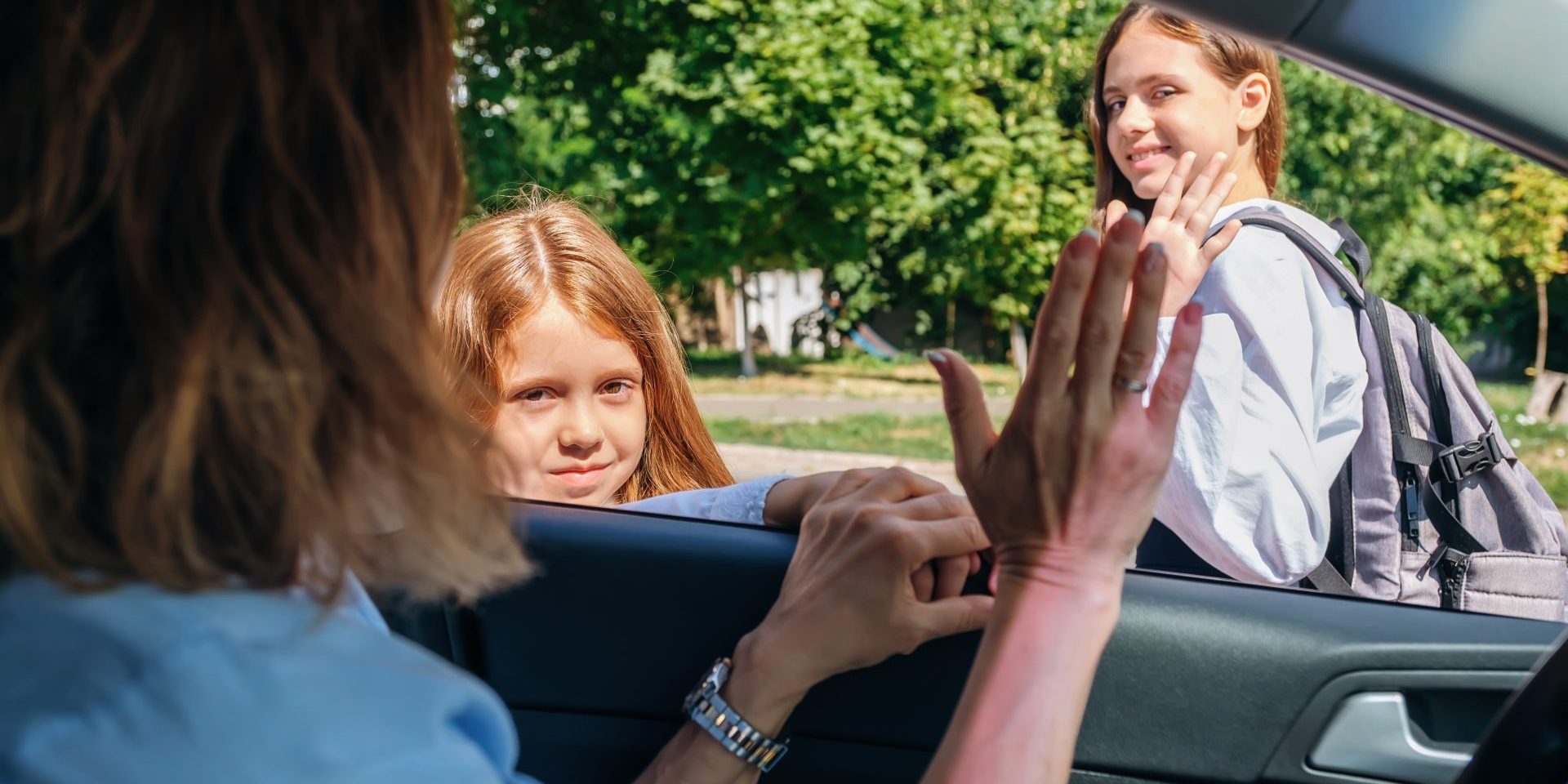 Mother,Sitting,Inside,The,Car,And,Gesturing,With,Hand,Goodbye