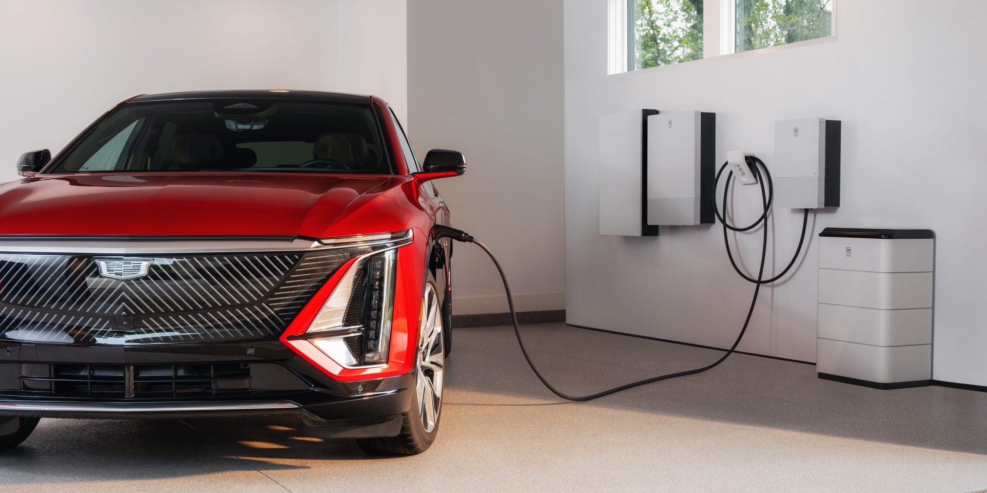 A Cadillac LYRIQ charging with the GM Energy Home System bundle in a residential garage. The GM Energy PowerBank is now available as of Thursday, Oct. 10, 2024, in all 50 states across America for purchase as part of the GM Energy Home System bundle, which also includes a GM Energy PowerShift charger and GM Energy Vehicle-to-Home Enablement kit. (image copurtesy GM)