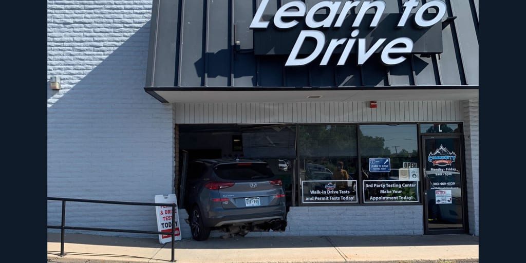 Video: Driving instructor crashes through wall of driving school